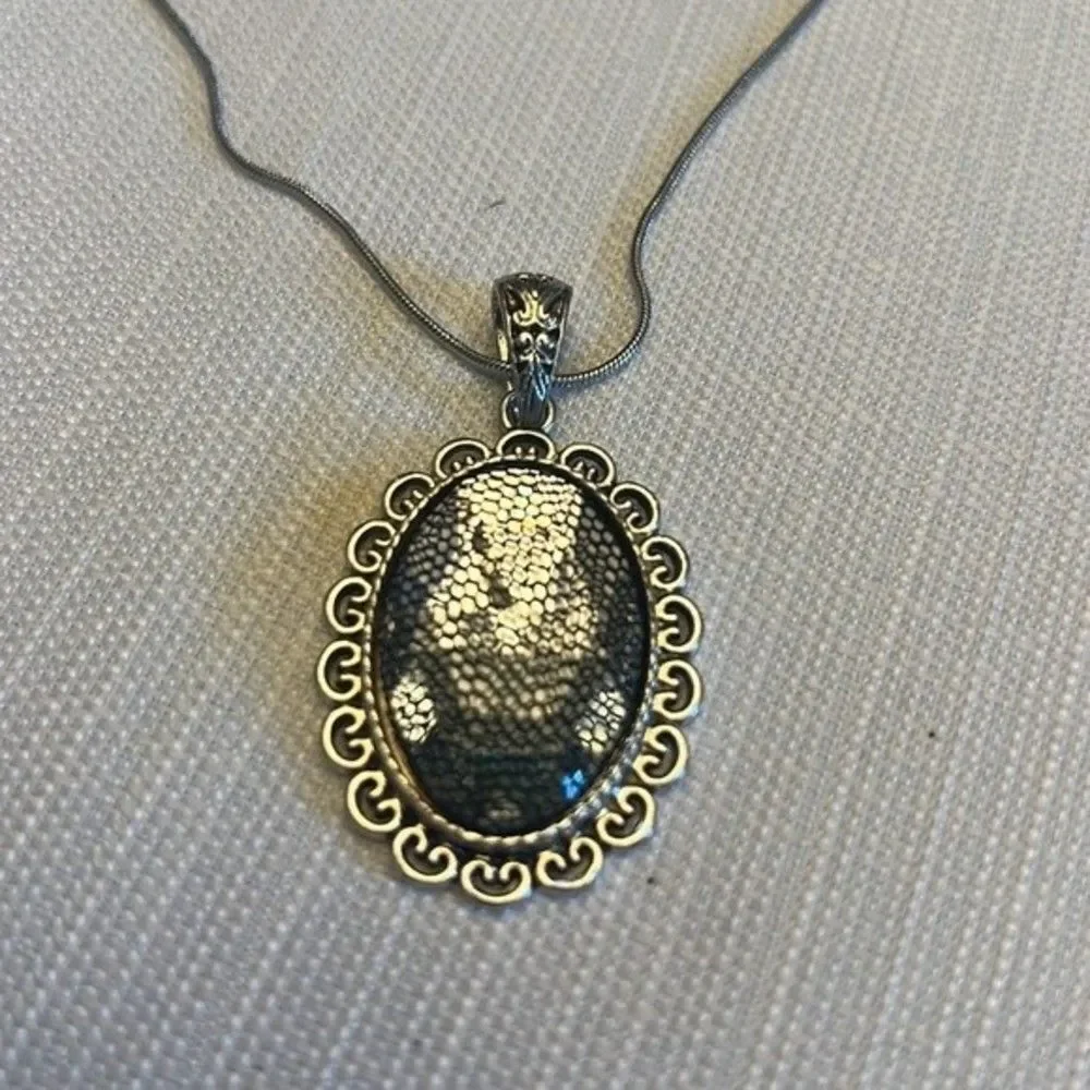 Handcrafted clear stone pendant with mesh overlay on silver tone chain